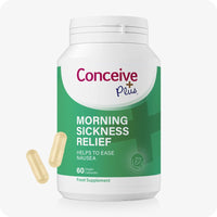 Conceive Plus Morning Sickness Relief supplement bottle with 60 vegan capsules to ease nausea during pregnancy. Green and white label features calming graphics and highlights ginger root as a key ingredient. Two soft yellow capsules are shown beside the bottle.