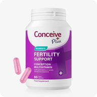 Conceive Plus Women’s Fertility Support bottle with purple and white label, featuring 60 pink vegan capsules for conception support.