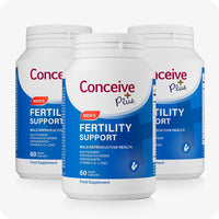 Three bottles of Conceive Plus Men’s Fertility Support arranged in a triangle on a white background, each featuring blue and white packaging with red accents, designed to promote male reproductive health and improve sperm quality.