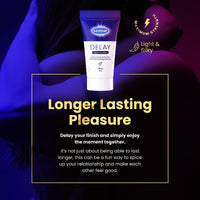 A tube of Sasmar Delay lubricant is centered against a dark, stylized background with blue and purple lighting and a blurred human body. Large text reads 'Longer Lasting Pleasure' with smaller descriptive copy below, and circular badges mention 'Light & Silky' and 'Maximum Strength'.